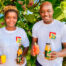 The Akoua team showcasing Cashew apple juice and lemonade in front of the beautiful cashew nut tree