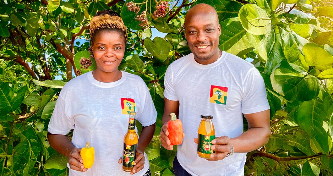 The Akoua team showcasing Cashew apple juice and lemonade in front of the beautiful cashew nut tree